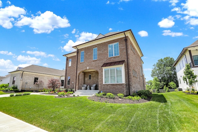 view of front of property featuring brick siding and a front lawn