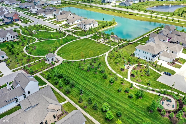 birds eye view of property with a water view and a residential view