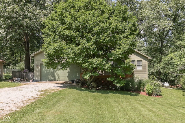 view of front of house with driveway, fence, and a front lawn