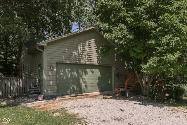 view of side of property with a garage and fence