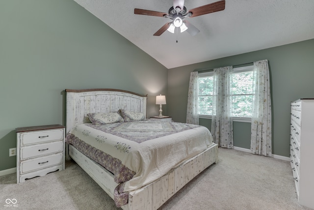 carpeted bedroom featuring vaulted ceiling, a textured ceiling, baseboards, and ceiling fan