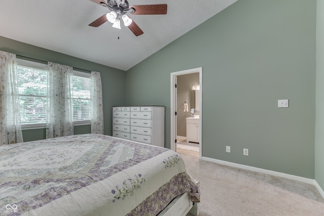 bedroom featuring light carpet, baseboards, connected bathroom, lofted ceiling, and ceiling fan