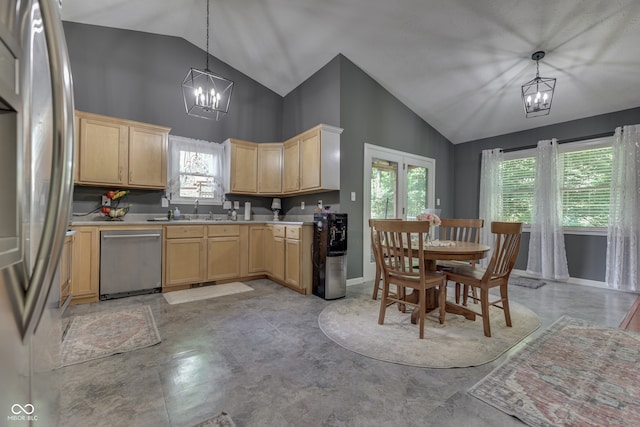 kitchen featuring light countertops, stainless steel appliances, a notable chandelier, and light brown cabinetry