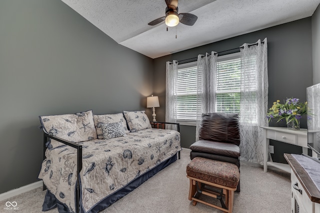 bedroom with lofted ceiling, carpet flooring, ceiling fan, a textured ceiling, and baseboards