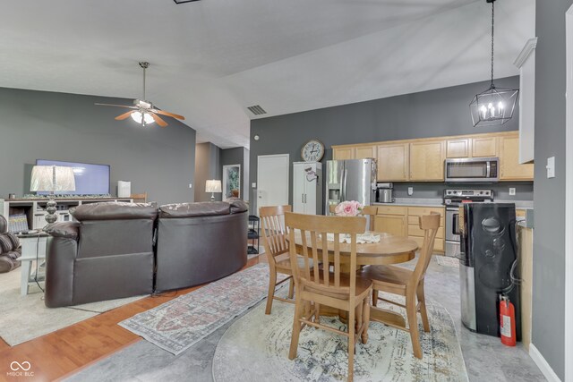 dining room with visible vents, baseboards, ceiling fan, light wood-style flooring, and high vaulted ceiling