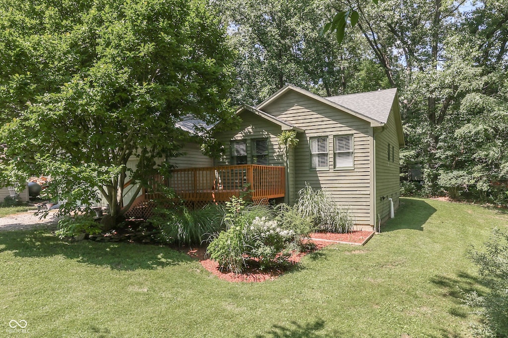 exterior space with a deck and a front yard