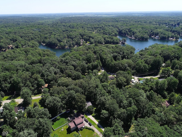 birds eye view of property with a water view and a view of trees