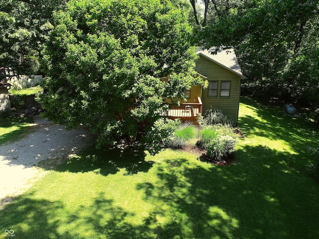 view of yard featuring gravel driveway and a wooden deck