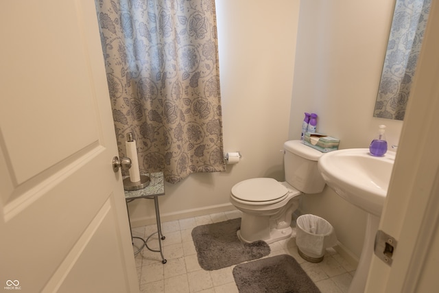 bathroom with tile floors and toilet