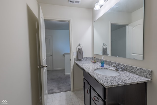 bathroom with tile flooring and vanity with extensive cabinet space