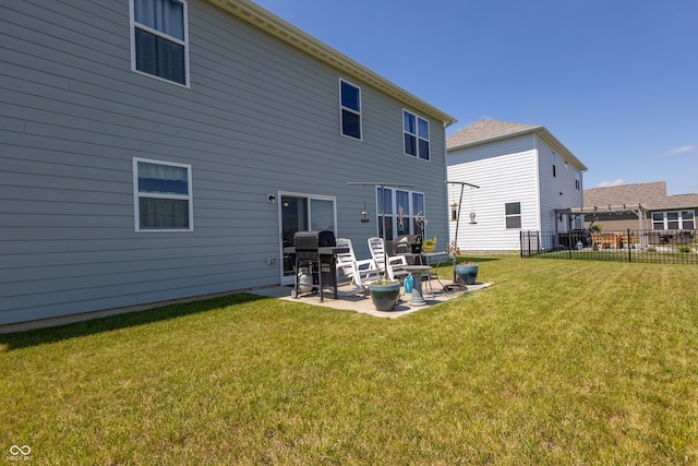 rear view of property with a patio area and a yard