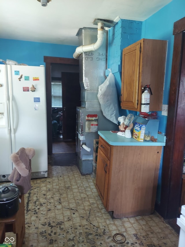 kitchen with white refrigerator with ice dispenser