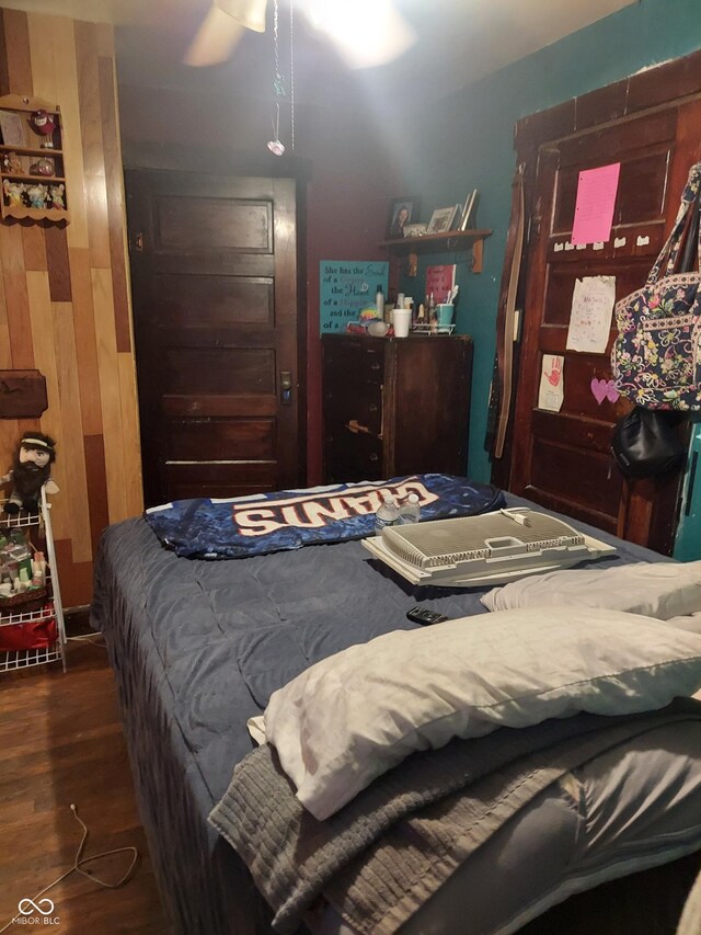 bedroom with ceiling fan and dark wood-type flooring