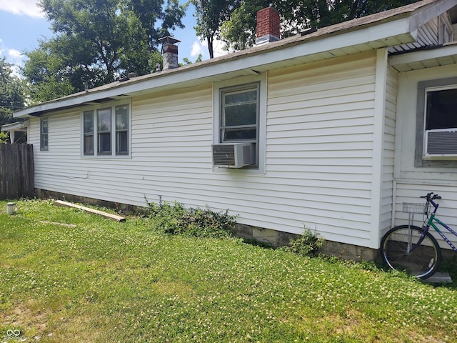 view of property exterior featuring cooling unit and a lawn