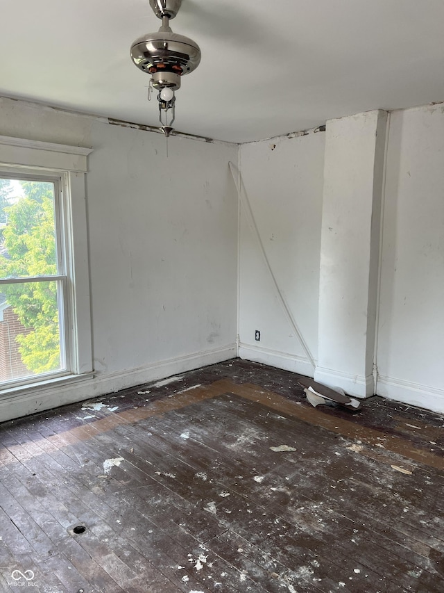 unfurnished room with dark wood-type flooring