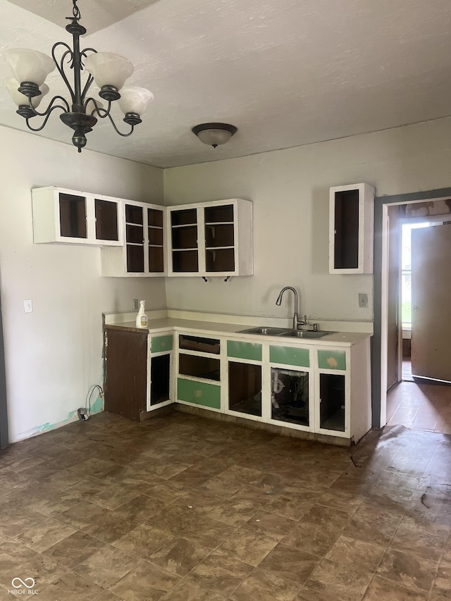 kitchen with a notable chandelier, sink, and hanging light fixtures