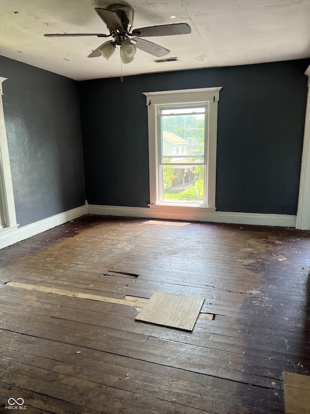 unfurnished room with ceiling fan and dark hardwood / wood-style flooring