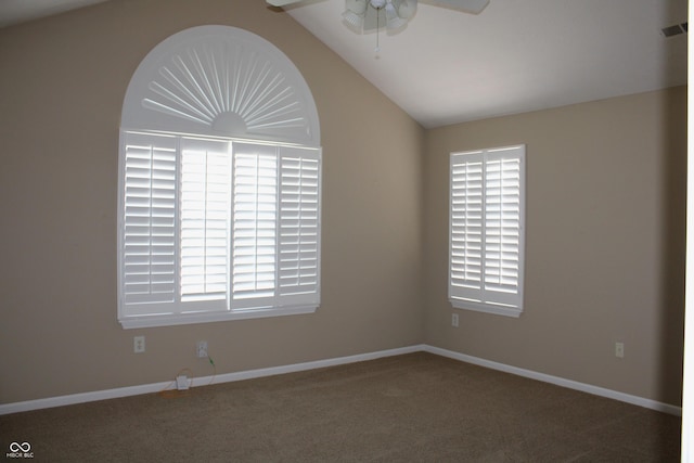 carpeted spare room featuring a wealth of natural light, ceiling fan, and vaulted ceiling