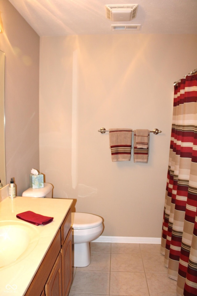 bathroom with vanity, toilet, curtained shower, and tile patterned flooring