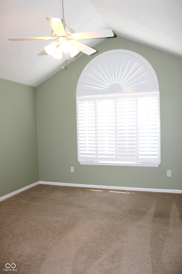 carpeted empty room with lofted ceiling and ceiling fan