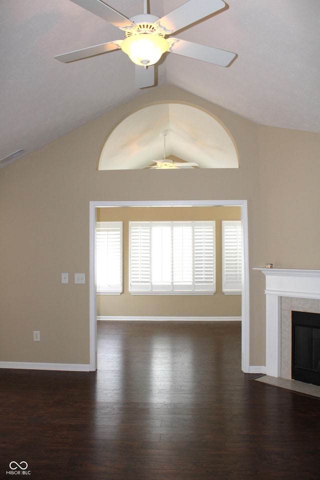 unfurnished living room featuring vaulted ceiling, a tile fireplace, and ceiling fan