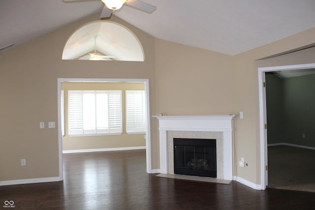 unfurnished living room with a tiled fireplace, ceiling fan, lofted ceiling, and dark hardwood / wood-style flooring