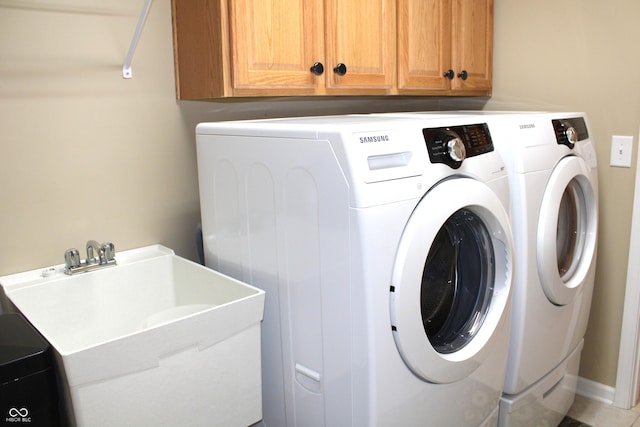 washroom with cabinets and separate washer and dryer