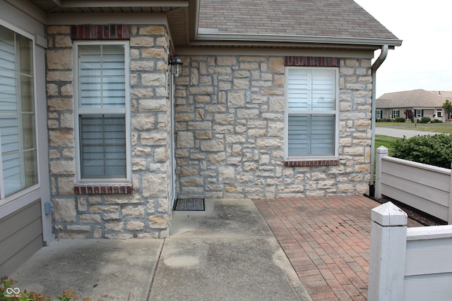 view of exterior entry with a patio