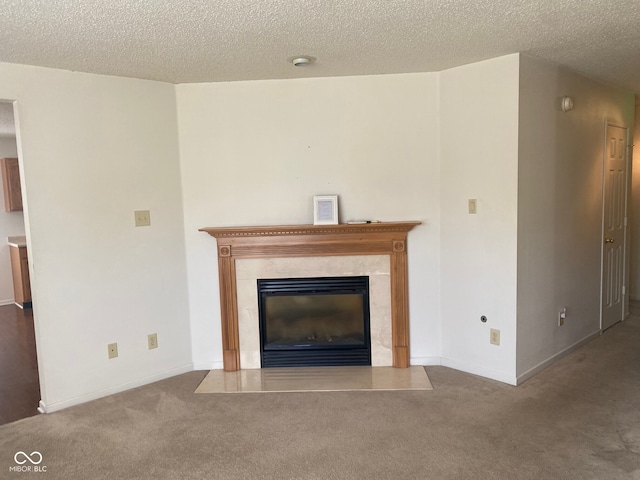 unfurnished living room with carpet flooring, a textured ceiling, and a fireplace