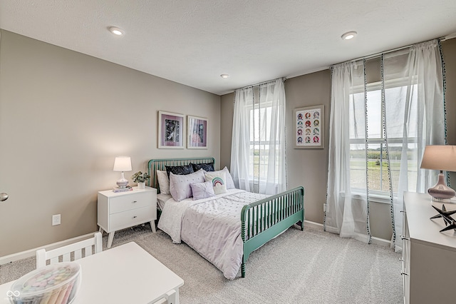 bedroom with carpet flooring and a textured ceiling