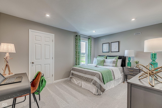 bedroom featuring carpet and a textured ceiling