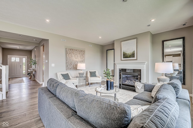 living room featuring light hardwood / wood-style floors and a fireplace