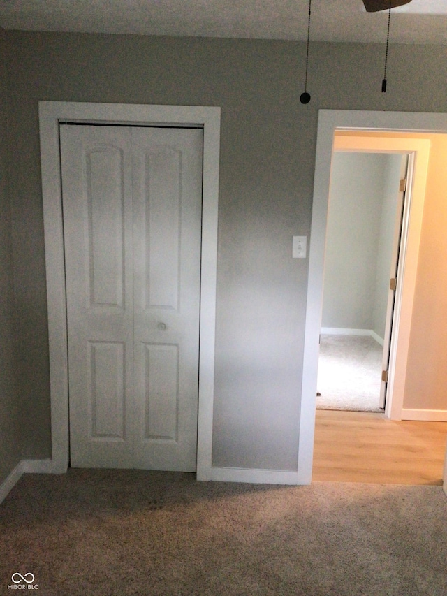 unfurnished bedroom with carpet floors and a closet