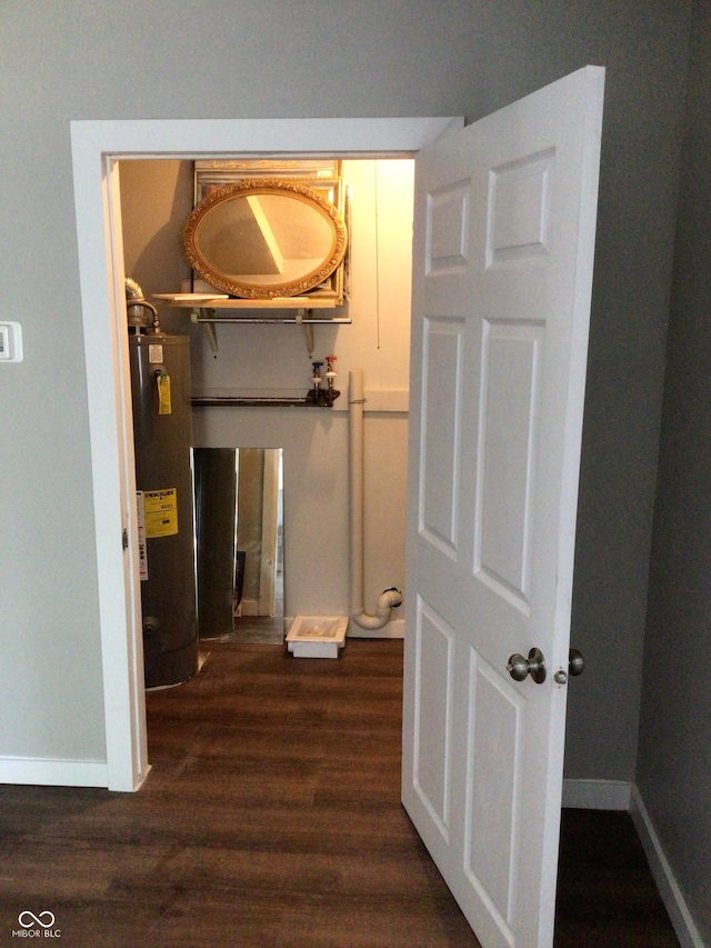 hall featuring water heater and dark hardwood / wood-style flooring