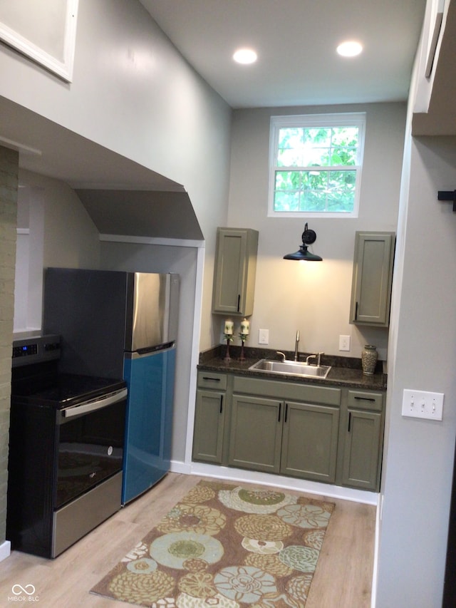 kitchen with sink, stainless steel range with electric cooktop, and light wood-type flooring