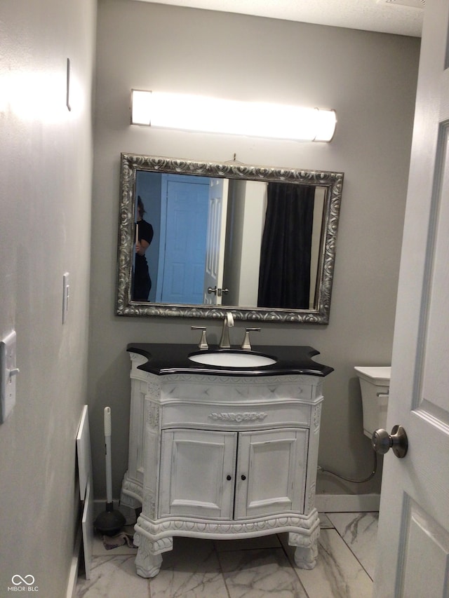 bathroom with vanity and toilet