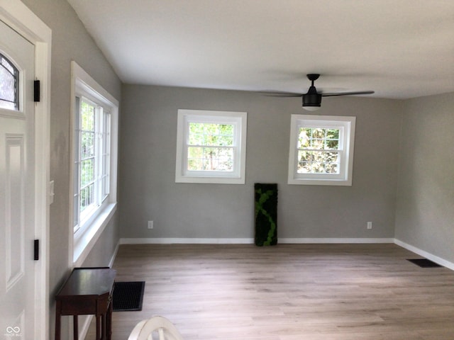 interior space with light hardwood / wood-style floors and ceiling fan