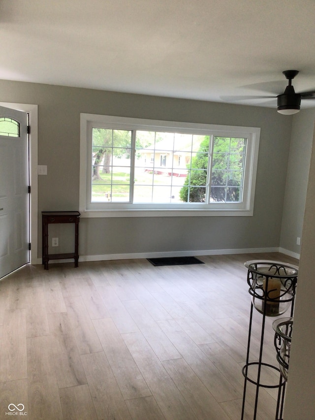 unfurnished living room with light hardwood / wood-style floors and ceiling fan