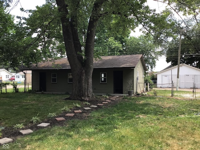 back of house with a yard