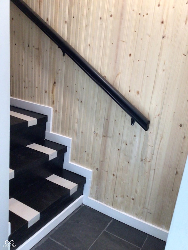 stairway with wood walls