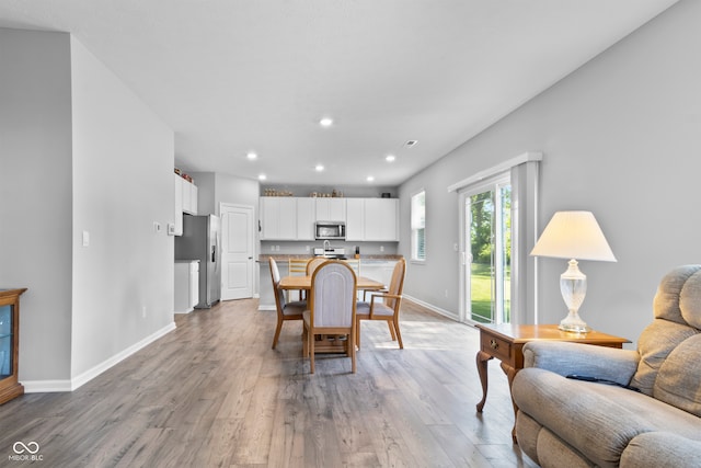 dining area with hardwood / wood-style flooring