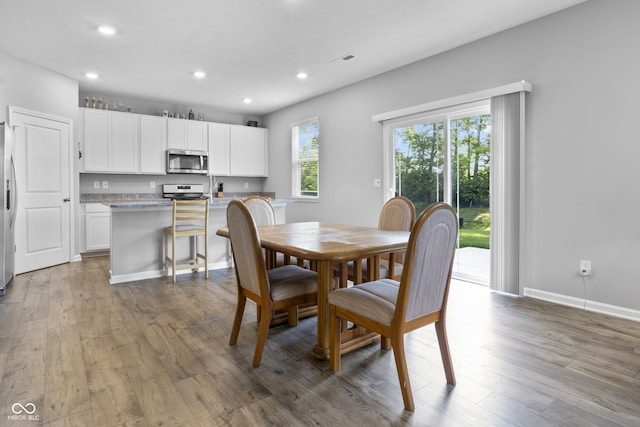 dining space featuring visible vents, baseboards, light wood-style flooring, and recessed lighting