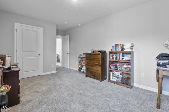 carpeted office featuring baseboards