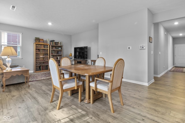 dining room with light wood-style floors, baseboards, visible vents, and recessed lighting