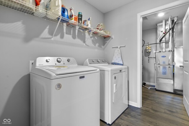 clothes washing area featuring washing machine and dryer and dark wood-type flooring