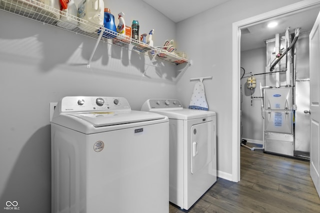 laundry room featuring washing machine and dryer, laundry area, dark wood finished floors, and baseboards