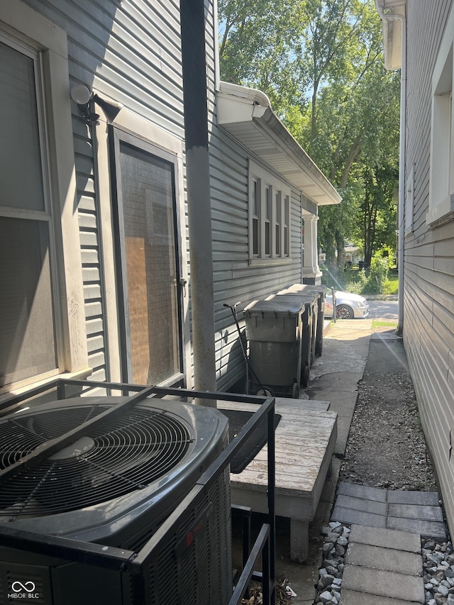 wooden deck featuring cooling unit