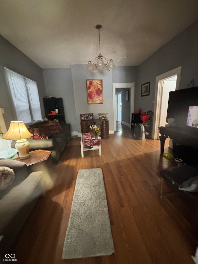 living room with wood-type flooring and a chandelier