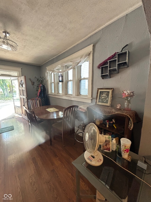 dining room featuring hardwood / wood-style floors and a textured ceiling