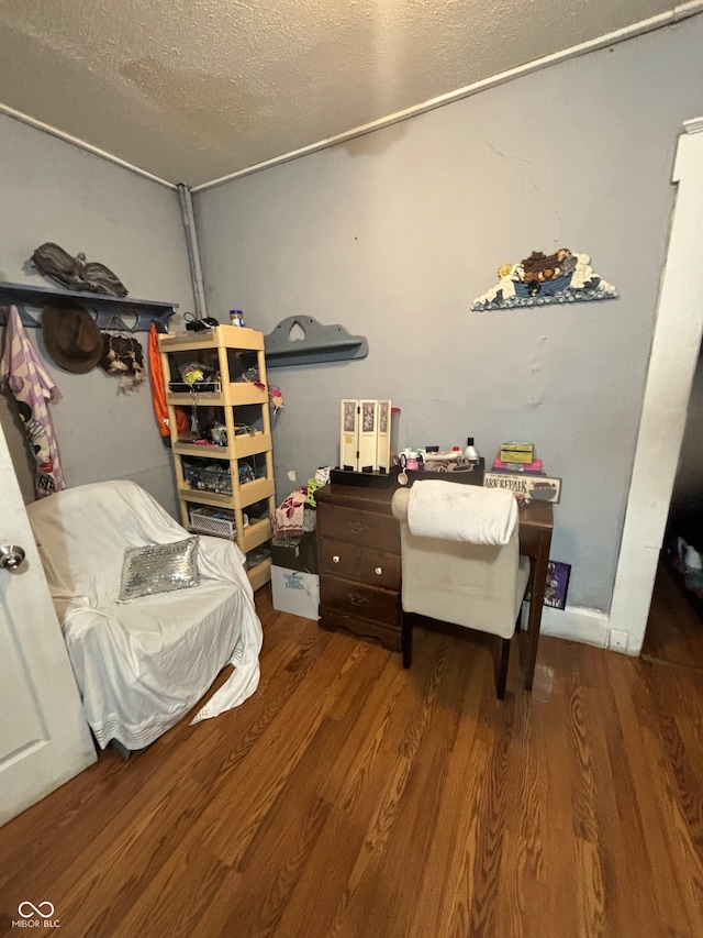 bedroom featuring hardwood / wood-style floors and a textured ceiling